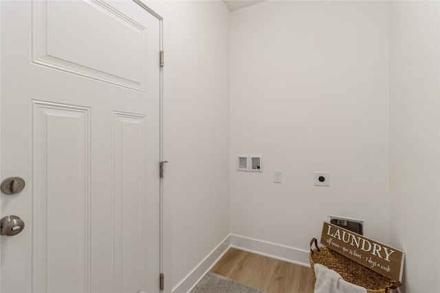 washroom featuring light hardwood / wood-style floors, hookup for a washing machine, and hookup for an electric dryer