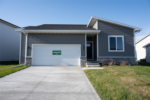 view of front facade with a front yard and a garage