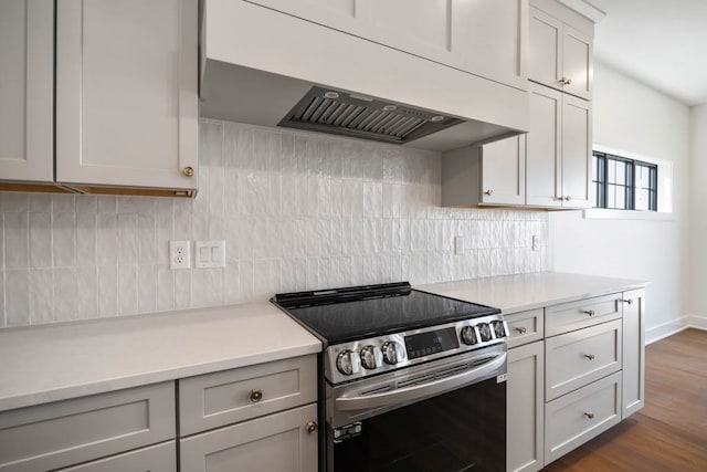 2814 NW Westwood Ct, Ankeny, IA 50023 - kitchen with backsplash, dark hardwood / wood-style flooring, wall chimney range hood, and stainless steel electric stove