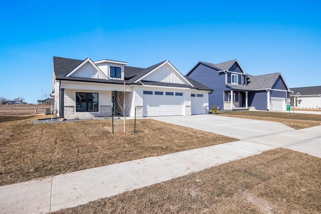 craftsman-style home featuring covered porch, a front yard, and a garage