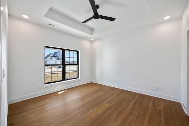2814 NW Westwood Ct, Ankeny, IA 50023 - empty room featuring a tray ceiling, ceiling fan, and dark hardwood / wood-style floors