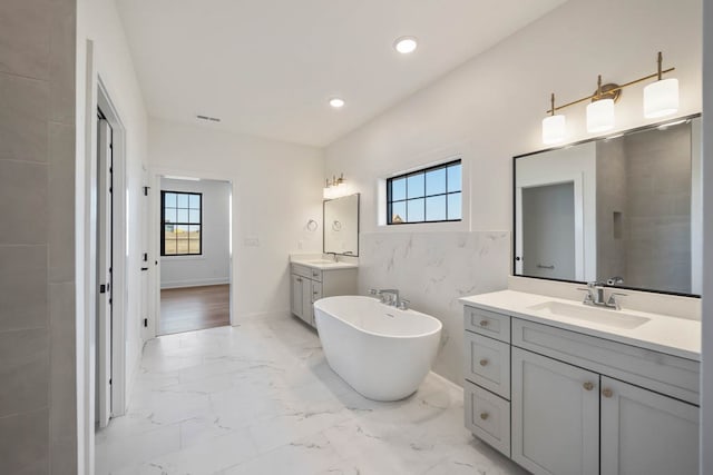 2814 NW Westwood Ct, Ankeny, IA 50023 - bathroom featuring plenty of natural light, a bathing tub, tile floors, and double sink vanity