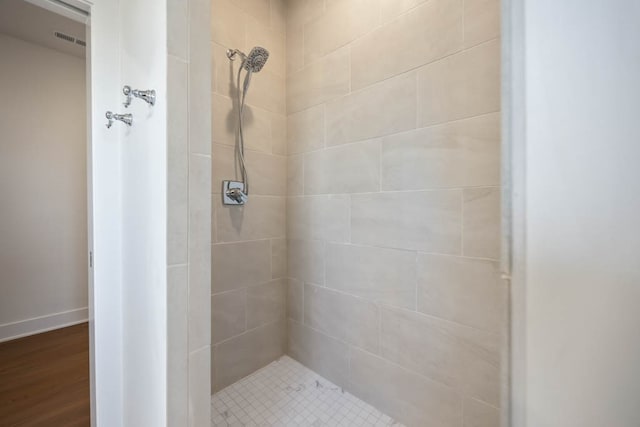 2814 NW Westwood Ct, Ankeny, IA 50023 - bathroom featuring hardwood / wood-style floors and tiled shower