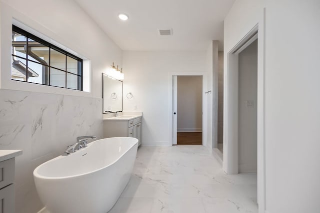 2814 NW Westwood Ct, Ankeny, IA 50023 - bathroom with vanity, tile floors, a washtub, and tile walls