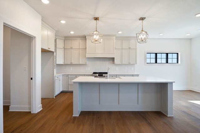 2814 NW Westwood Ct, Ankeny, IA 50023 - kitchen featuring backsplash, pendant lighting, a center island with sink, and dark hardwood / wood-style floors