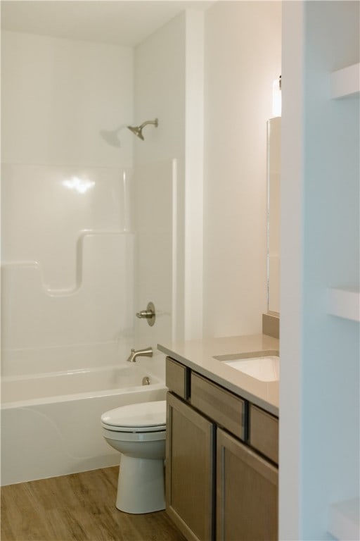 full bathroom with toilet, bathtub / shower combination, vanity, and hardwood / wood-style flooring