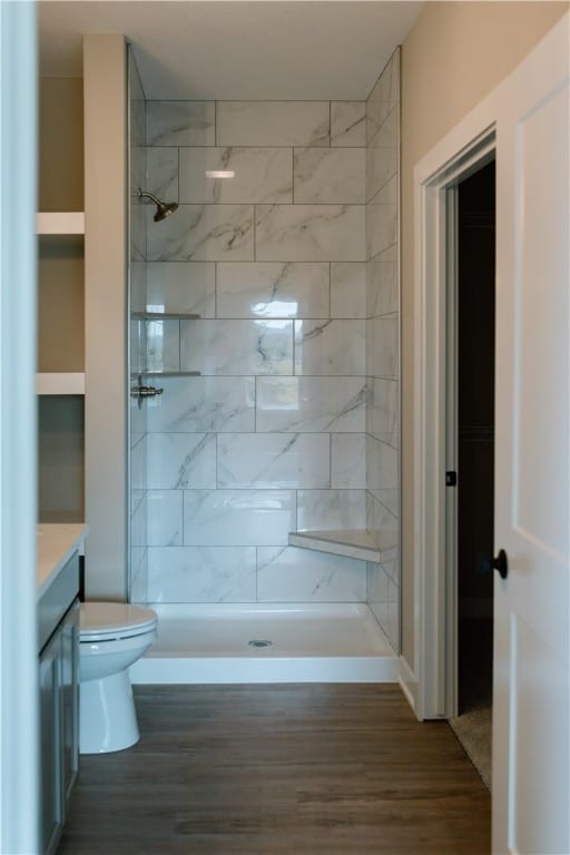 bathroom featuring vanity, wood-type flooring, and toilet