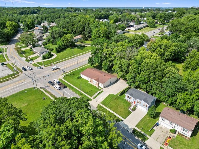 drone / aerial view with a forest view and a residential view
