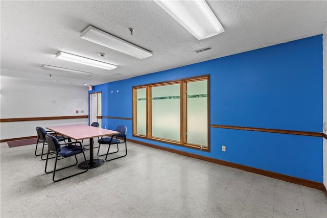 playroom with tile patterned floors, baseboards, visible vents, and a textured ceiling