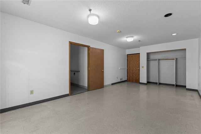 interior space with baseboards and a textured ceiling