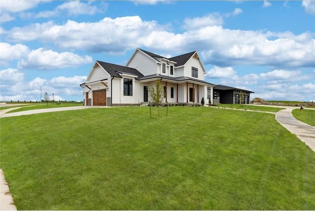 view of front of property with a front yard and a garage