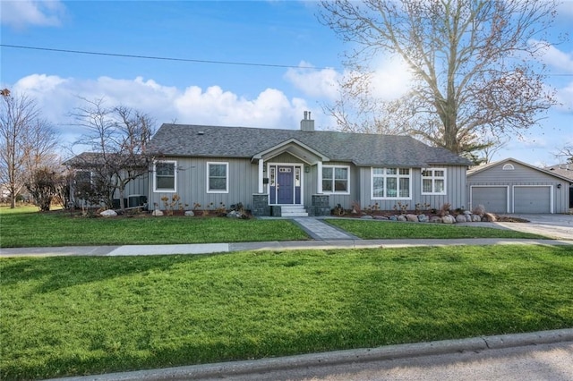 single story home with a garage, an outdoor structure, and a front yard