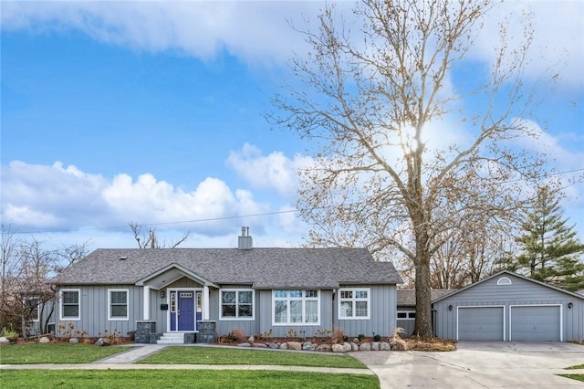 ranch-style house featuring a garage, an outdoor structure, and a front lawn