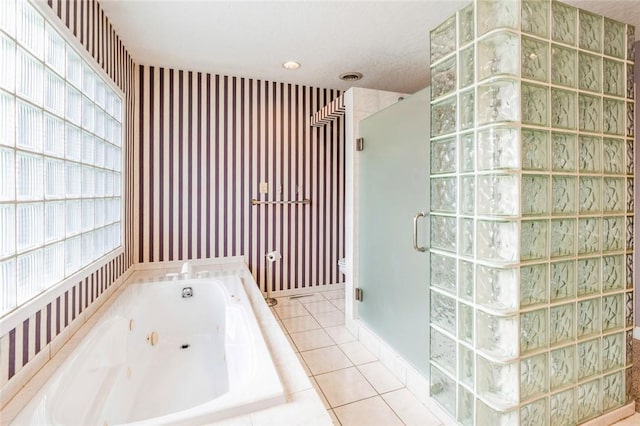 bathroom with tile patterned floors and independent shower and bath