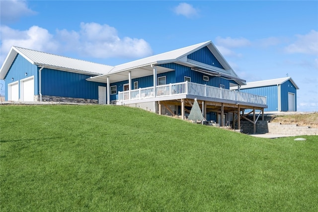 rear view of property featuring a lawn