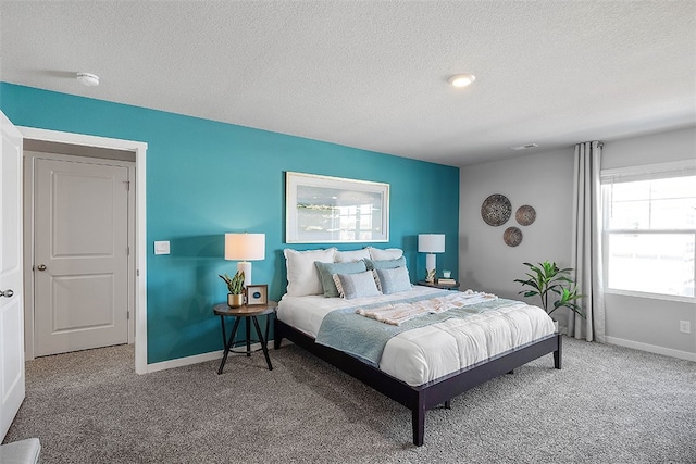 bedroom with carpet and a textured ceiling