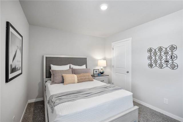 bedroom with dark colored carpet