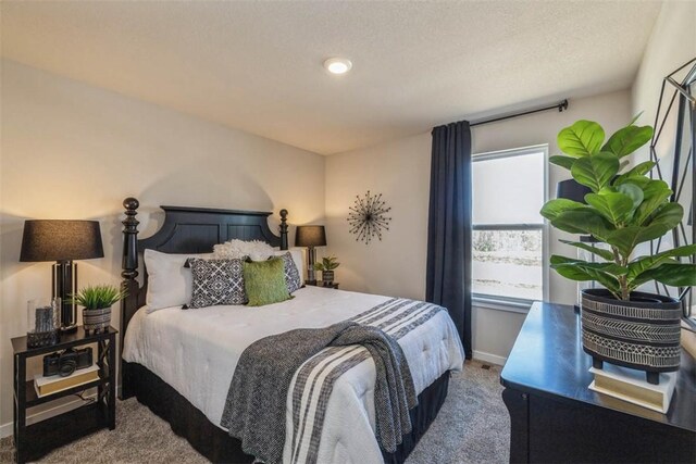 bedroom with a textured ceiling and carpet floors