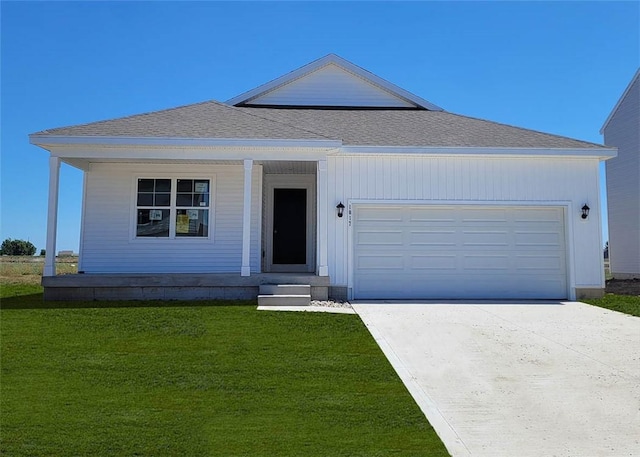 view of front of house with a front yard and a garage