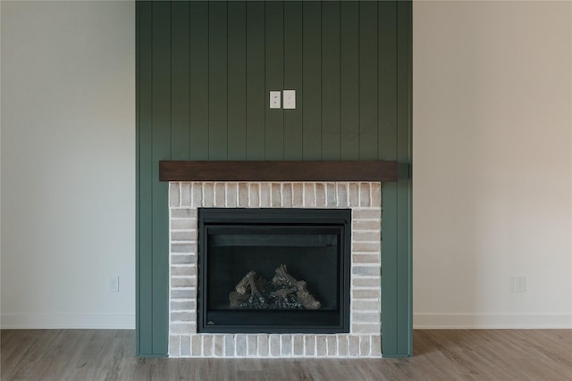 details with wood walls and hardwood / wood-style flooring