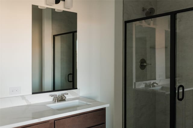 bathroom with vanity and a shower with shower door