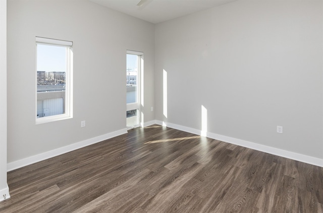 spare room featuring dark hardwood / wood-style floors and ceiling fan