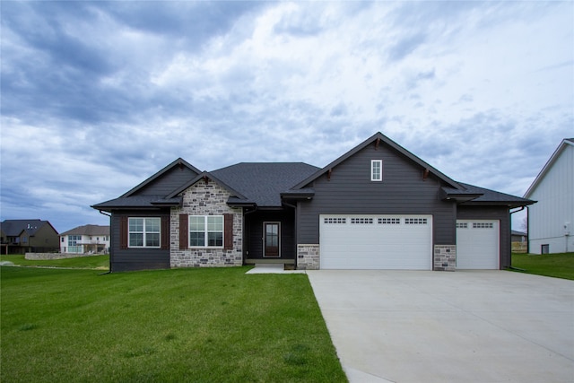 craftsman house with a garage and a front yard