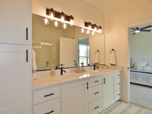 bathroom with tile patterned flooring, a tile shower, vanity, and ceiling fan