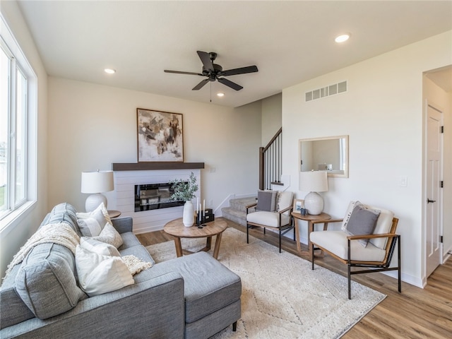 living room with ceiling fan and light hardwood / wood-style flooring