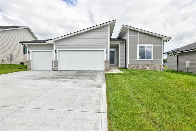 view of front of house with a garage and a front lawn