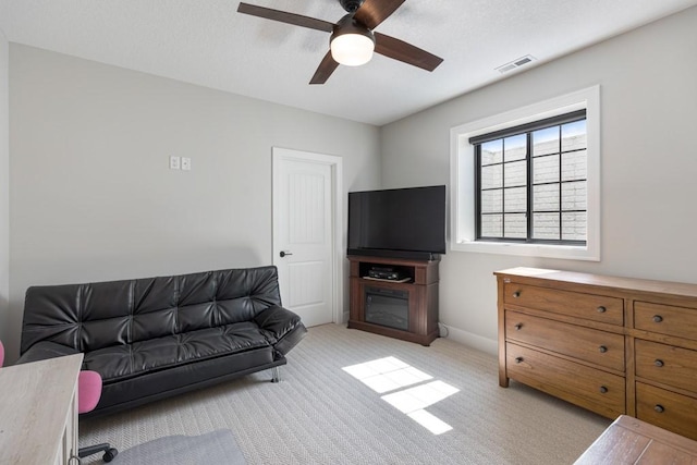 carpeted living room featuring ceiling fan