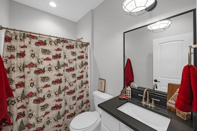 bathroom featuring toilet, vanity, and a shower with shower curtain