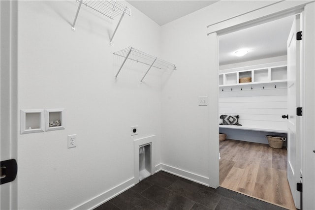 washroom featuring hookup for an electric dryer, hookup for a washing machine, and dark tile patterned floors