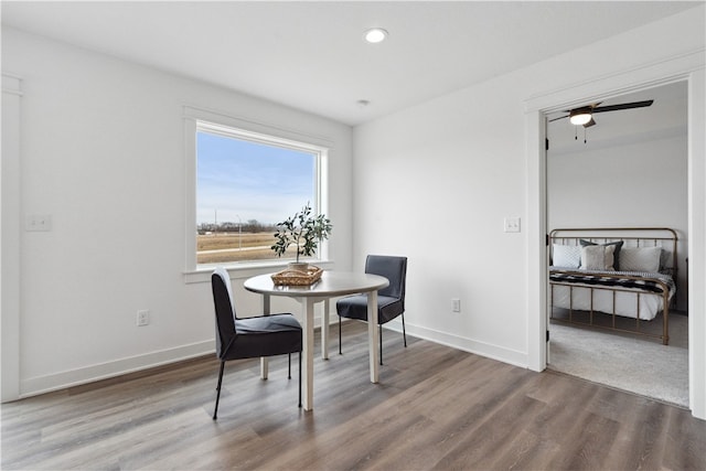 dining area featuring hardwood / wood-style floors and ceiling fan