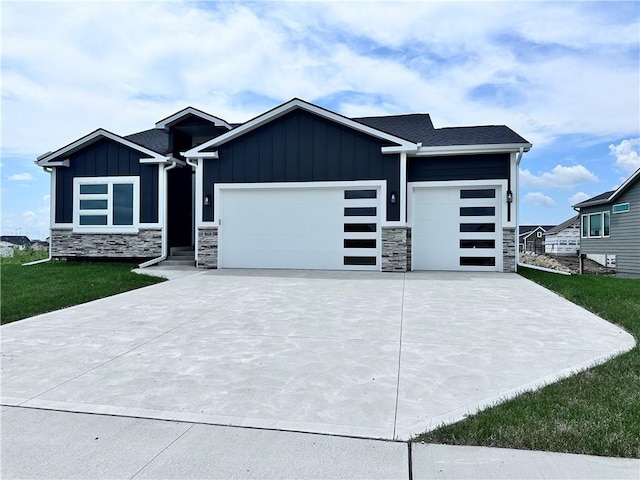 view of front of property featuring a garage and a front lawn