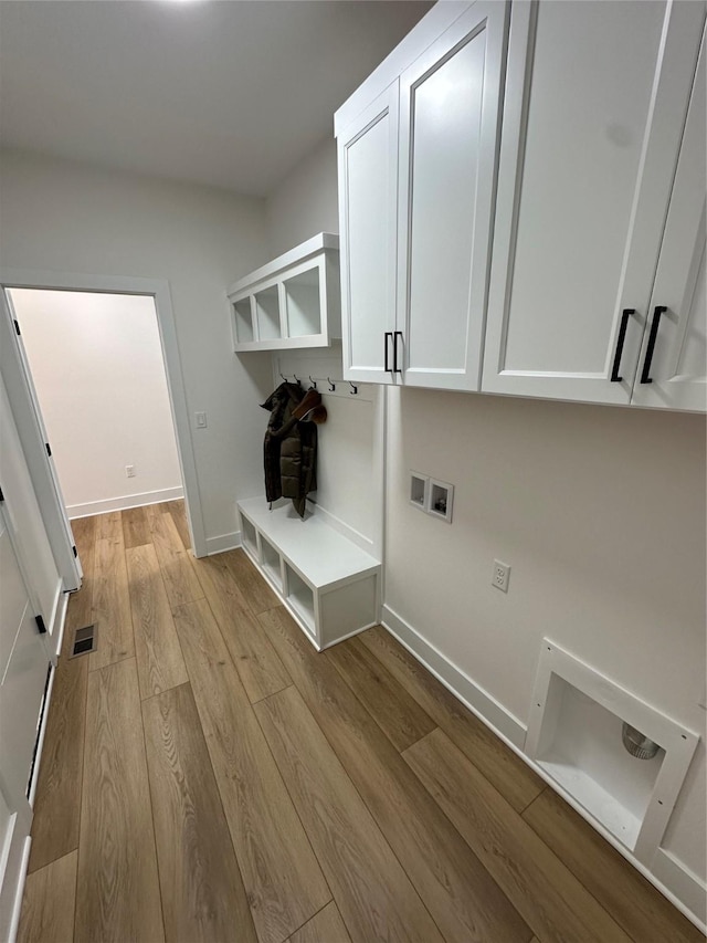 mudroom with light hardwood / wood-style floors