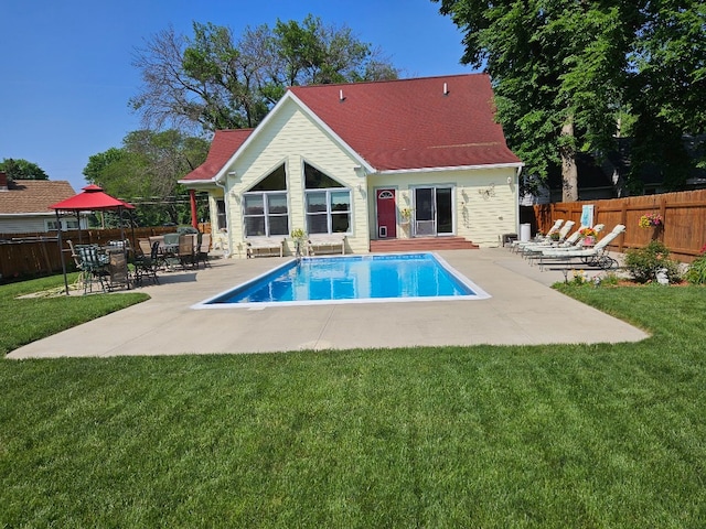 view of swimming pool featuring a lawn and a patio