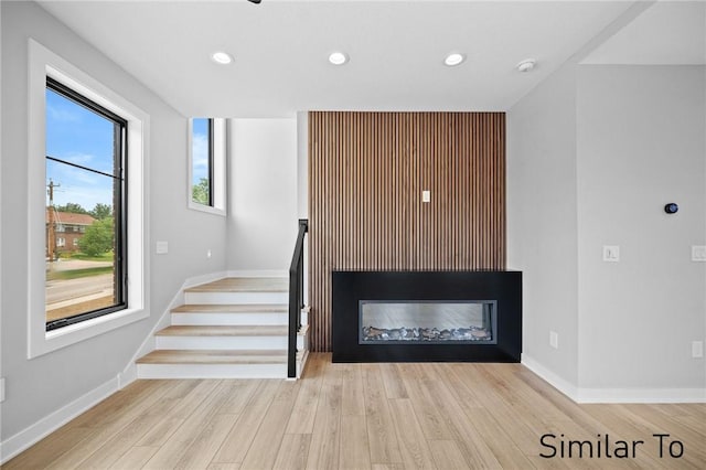 staircase with hardwood / wood-style flooring