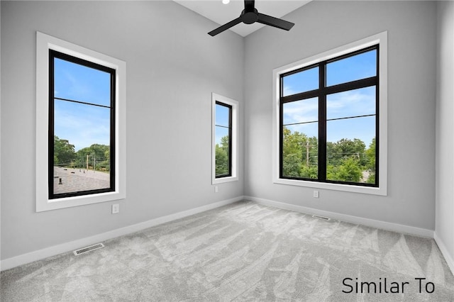 spare room featuring ceiling fan and carpet