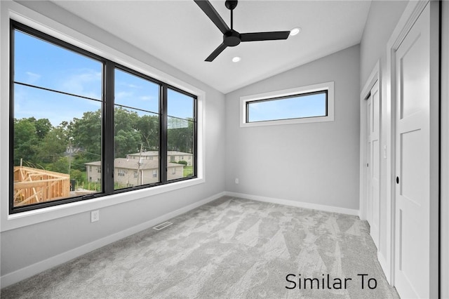 unfurnished bedroom with light carpet, vaulted ceiling, and ceiling fan