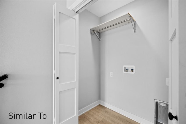 laundry room with washer hookup and light hardwood / wood-style flooring