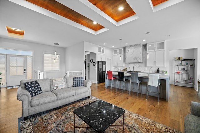 living room featuring light wood-type flooring and sink