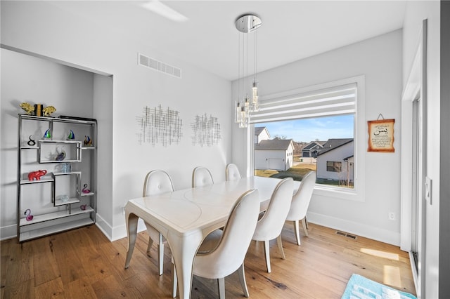 dining area with a chandelier and hardwood / wood-style floors