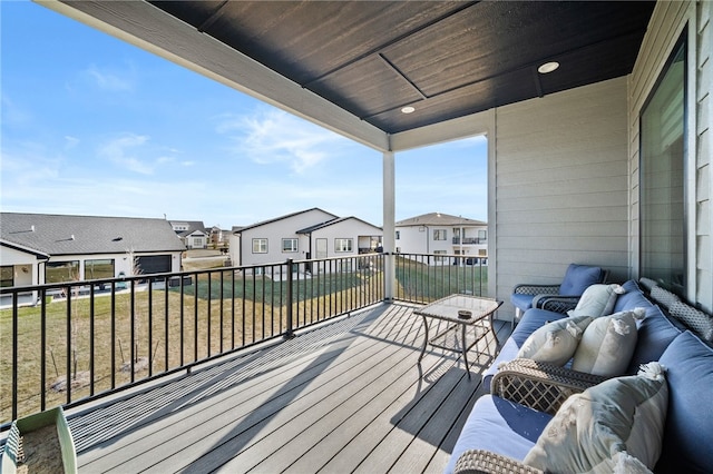 wooden deck featuring a lawn