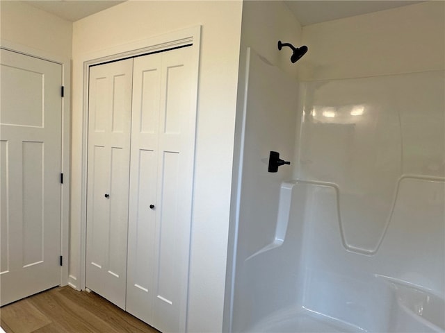 bathroom featuring a shower and wood-type flooring