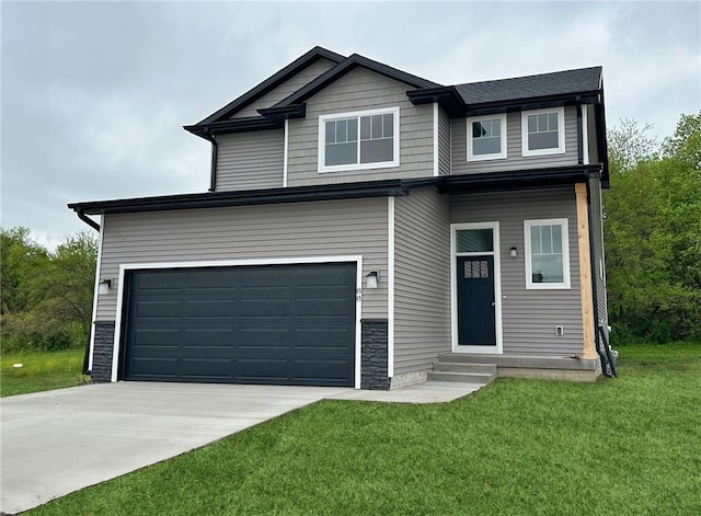 view of front of property featuring a front yard and a garage