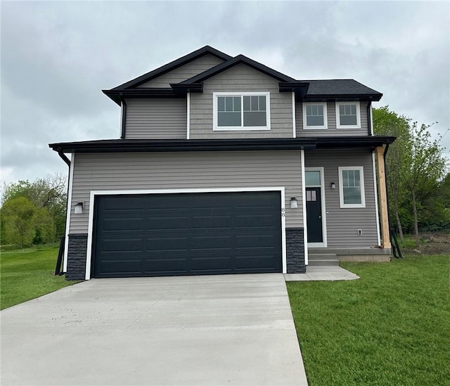 view of front of home featuring a garage and a front lawn