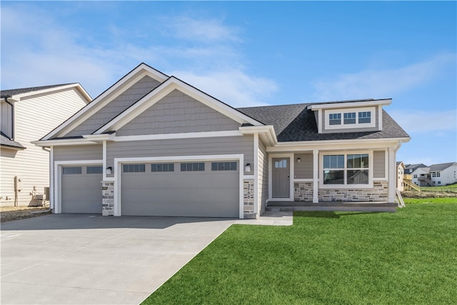 craftsman-style home featuring a front yard and a garage