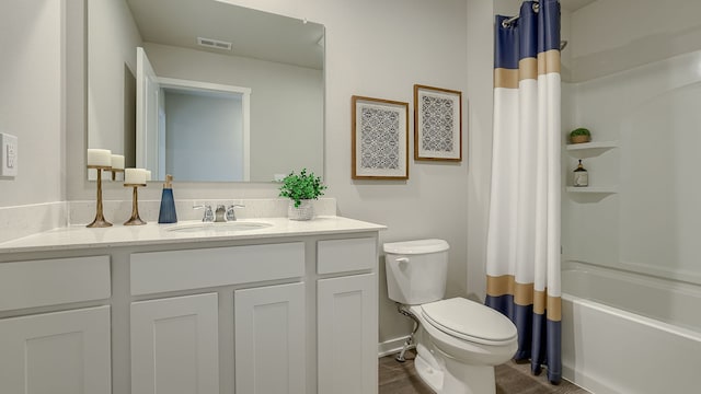 full bathroom featuring toilet, shower / tub combo with curtain, and vanity