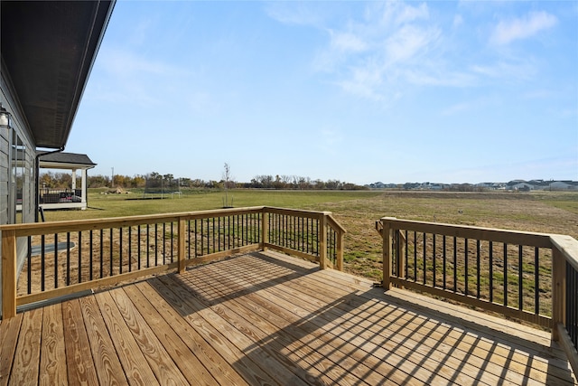 deck featuring a rural view and a yard